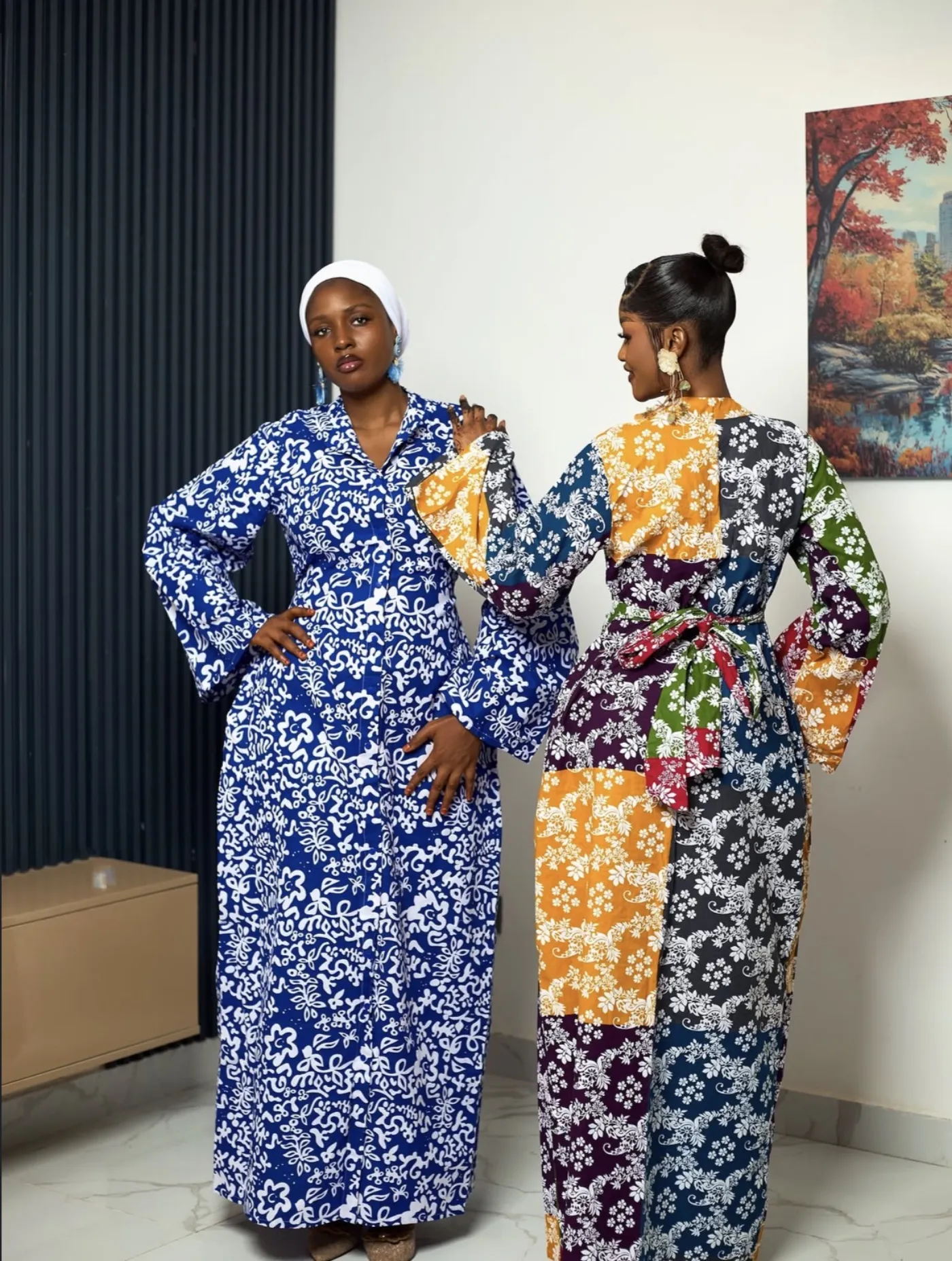 Two women in a cobalt batik shirt dress and a patchwork boubou